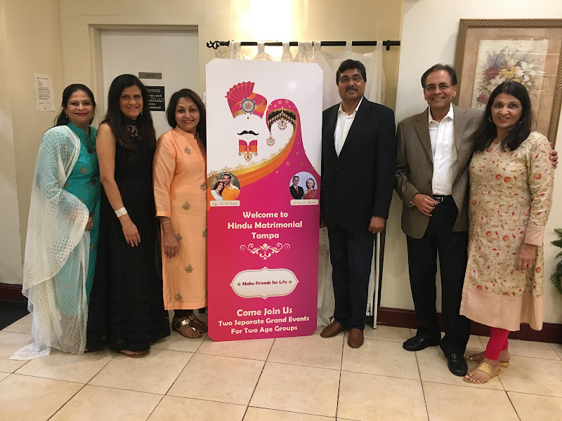 Organizers and volunteers standing with the Hindu Matrimonial Tampa banner